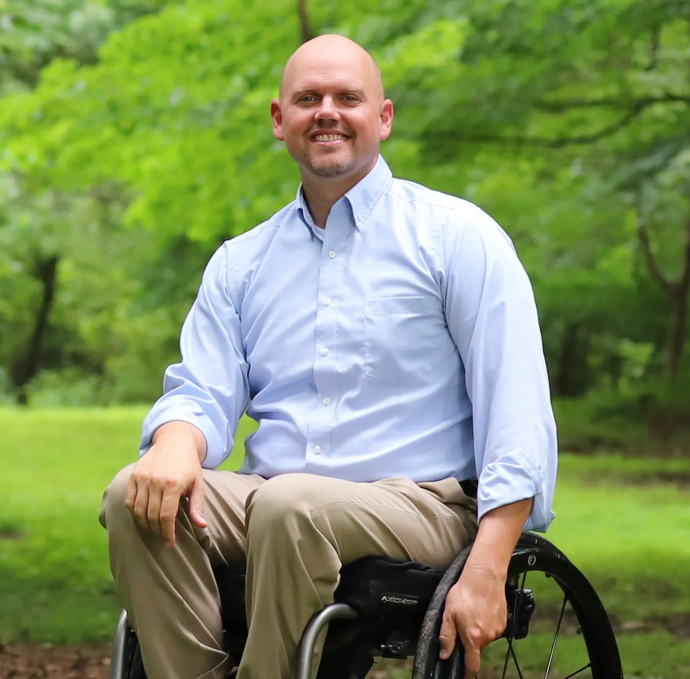 Jeff D. Harmon seated outdoors in his wheelchair